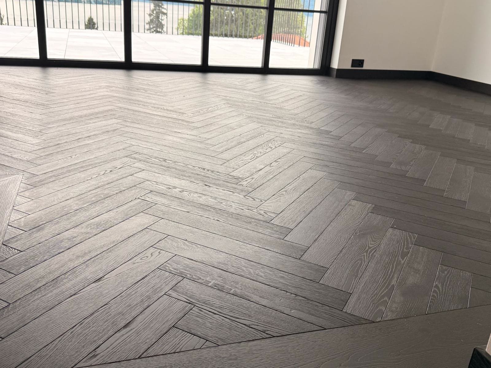 Graues Fischgrätparkett mit Seeblick